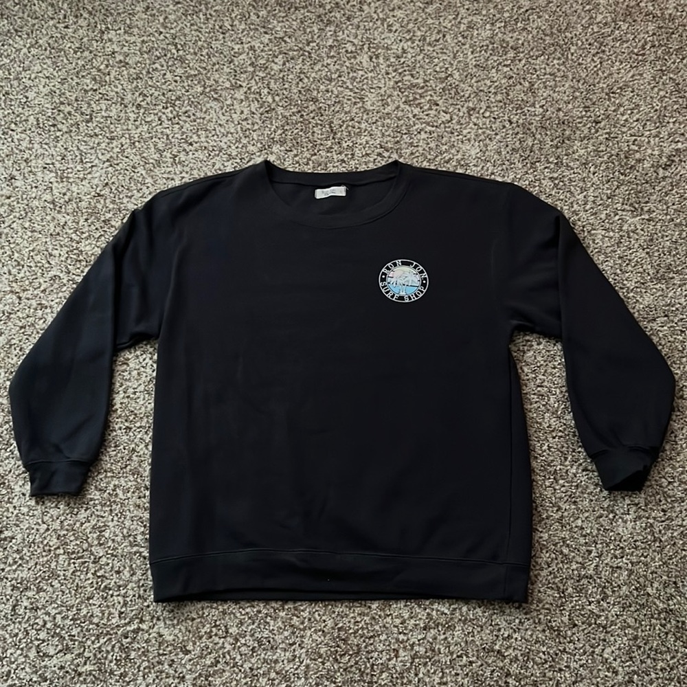 This Ron Jon crewneck is a women’s large and dark grey color
